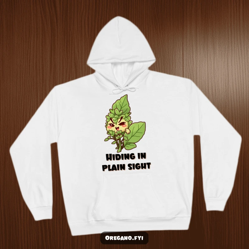 Funny hoodie: A slyly winking oregano character peeks from behind a large basil leaf, embodying mischief.
